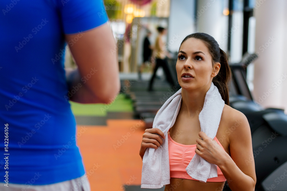 Young fit girl listening her fitness instructor