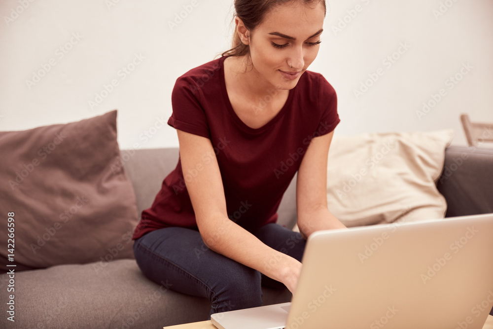 Pretty young woman relaxing with laptop Pretty young woman relaxing with laptop