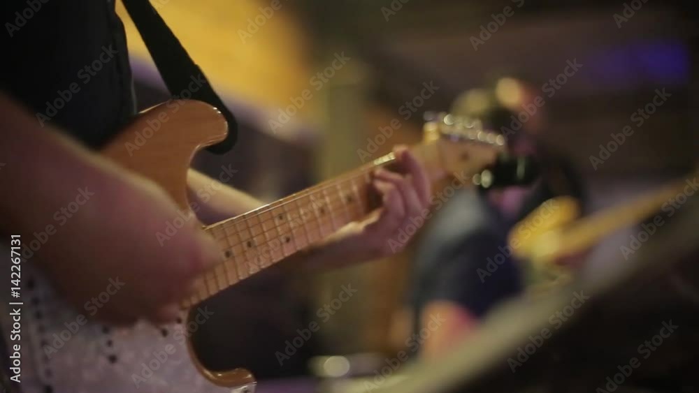 The guitarist plays an electric guitar at a concert The guitarist plays an electric guitar at a concert