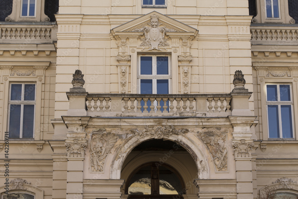 Facade of old building with three windows and balcony in Lviv