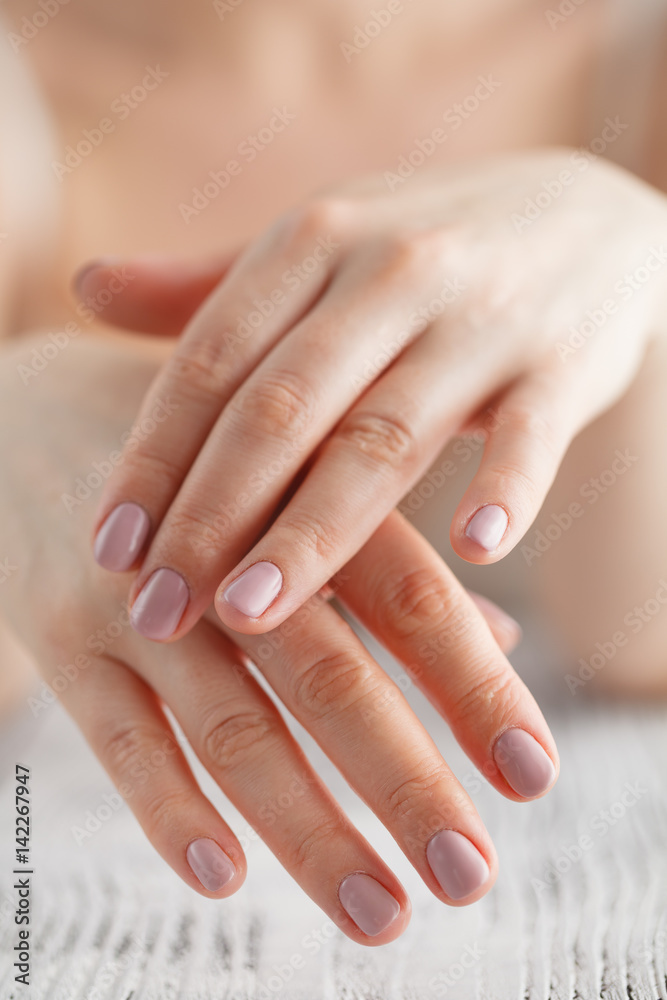 woman applies cream on her hands after bath. Focus on hands woman applies cream on her hands after bath. Focus on hands