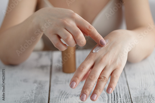 Beautiful female hands with cream photo