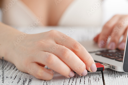 Surfing web at Sunday morning. closeup view of hand women in lingerie using computer