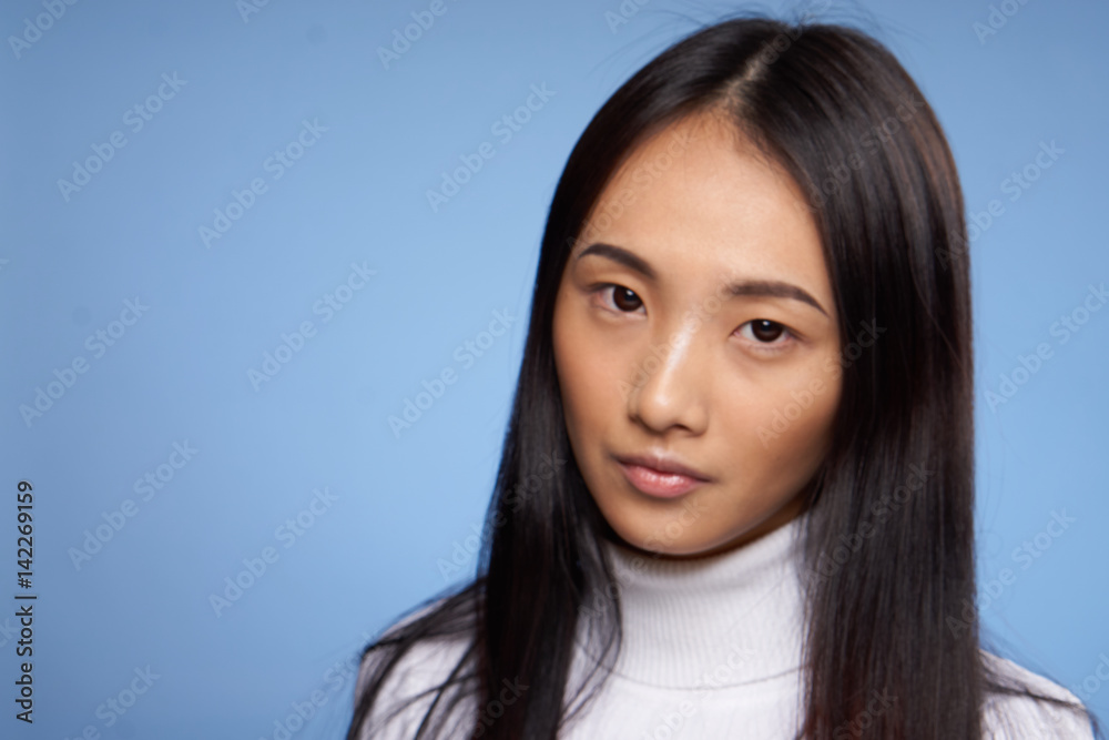 blue background and pretty woman in a white jacket blue background and pretty woman in a white jacket