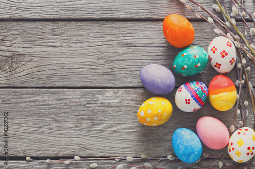 Photography Colorful easter eggs on wood background