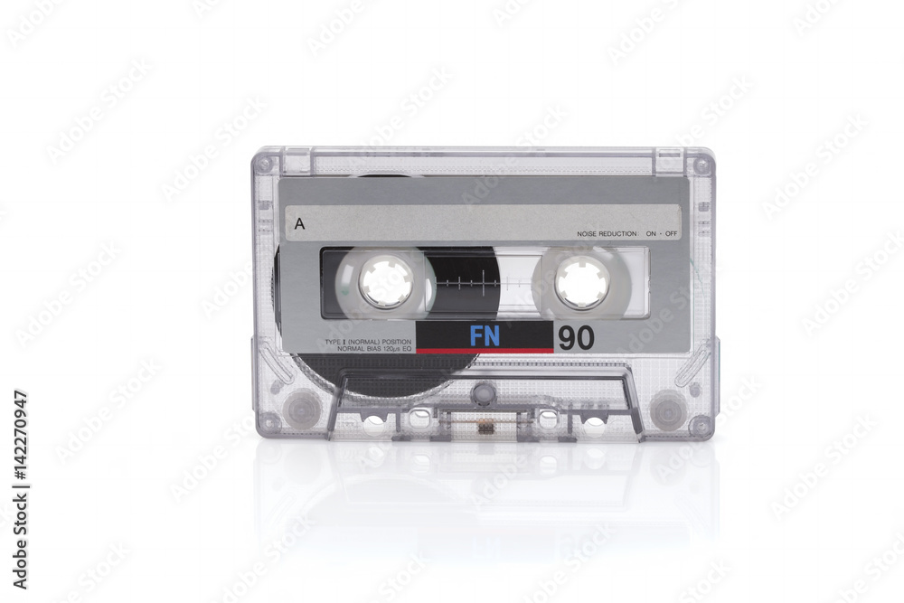 Vintage black compact cassette on white background