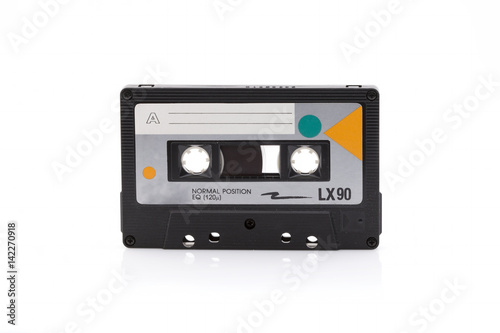 Vintage black compact cassette on white background
