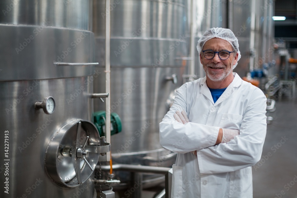 Smiling factory engineer with arms crossed Smiling factory engineer with arms crossed