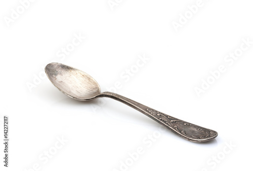 Old antique spoon on a white background