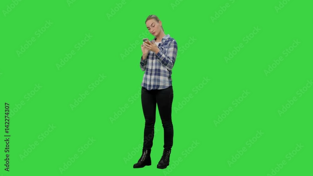 Tired working young woman reading messages on the phone on a Green Screen, Chroma Key. Tired working young woman reading messages on the phone on a Green Screen, Chroma Key.