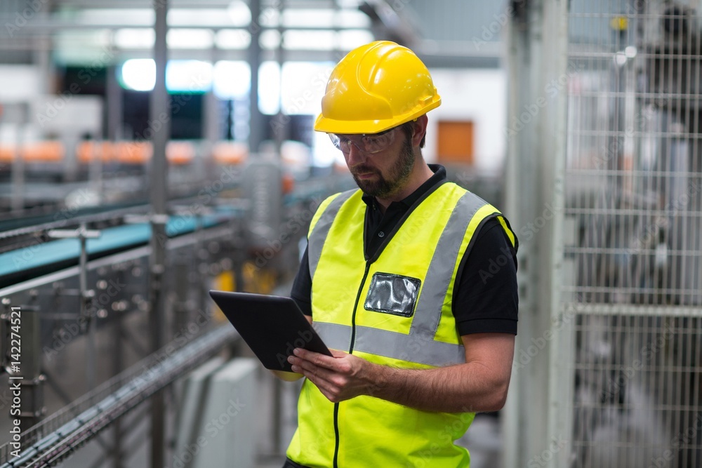 Factory worker using a digital tablet Factory worker using a digital tablet