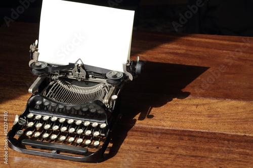Vintage typewriter on wooden desk contact me