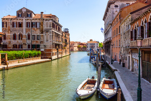 View of the canal with boats and gondolas in Venice  Italy. Venice is a popular tourist destination of Europe