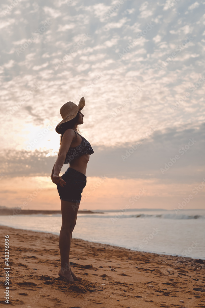 Joyful woman dancing in the sunset on beach background Joyful woman dancing in the sunset on beach background