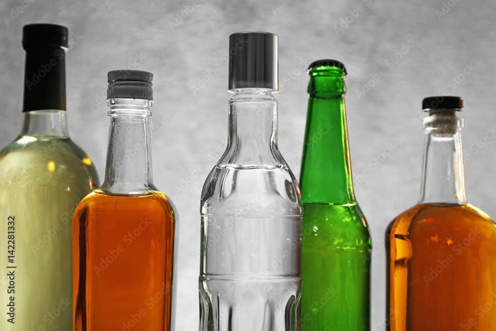 Different bottles of wine and spirits on color background Different bottles of wine and spirits on color background