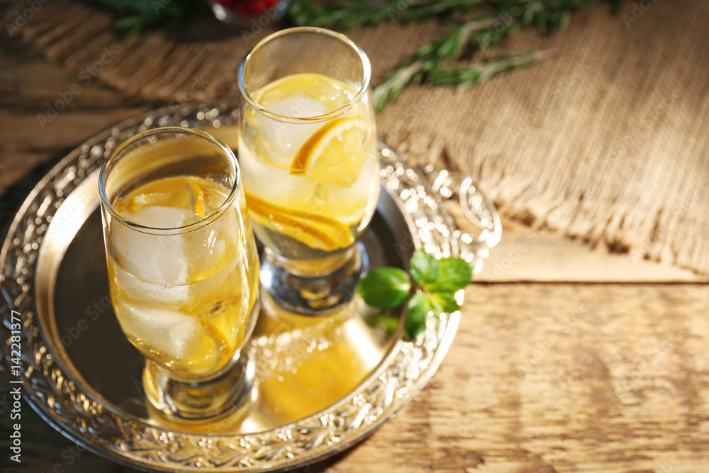 Glasses with delicious wine spritzer on silver tray Glasses with delicious wine spritzer on silver tray