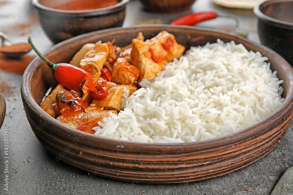Chicken tikka masala with rice in bowl, close up
