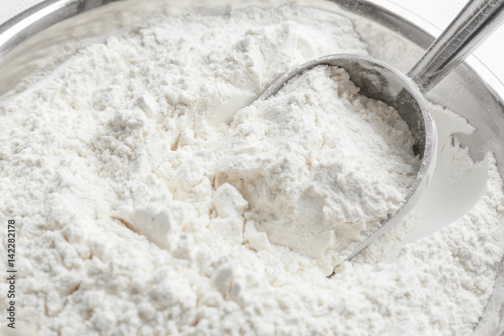 Metal scoop in flour, closeup