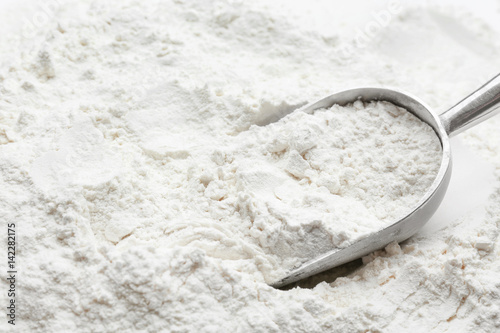 Metal scoop in flour, closeup