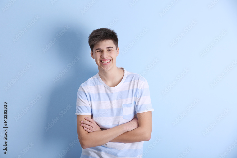 Teenager in casual clothes on light background Teenager in casual clothes on light background