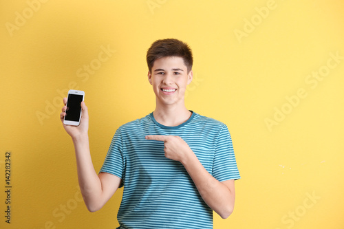 Teenage boy with mobile pho...