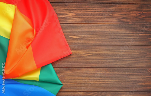 Rainbow gay flag on wooden background