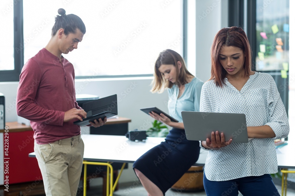 Business executive using laptop and digital tablet Business executive using laptop and digital tablet