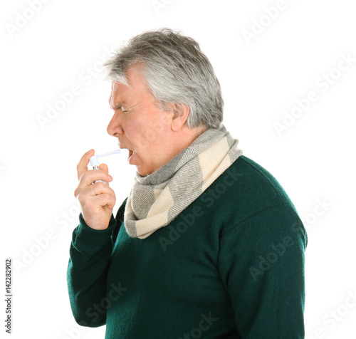Sick senior man using throa...