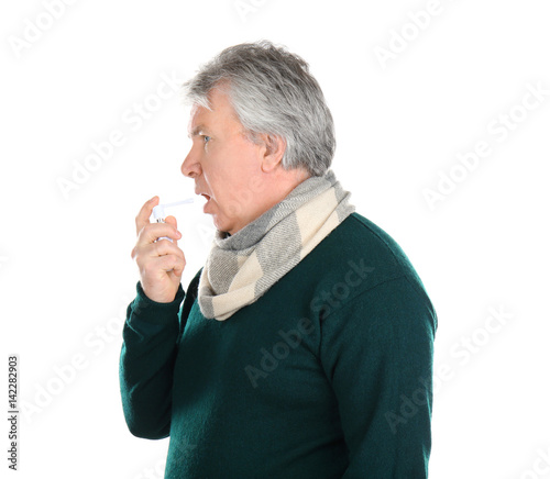 Sick senior man using throa...