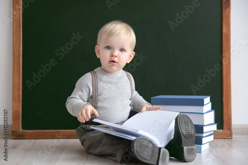 Cute little boy with books ...