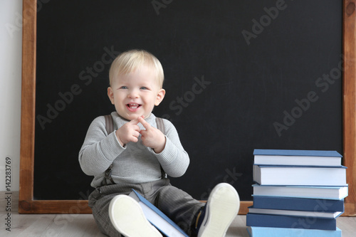 Cute little boy with books ...