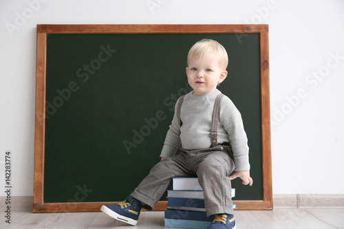 Cute little boy sitting on ...