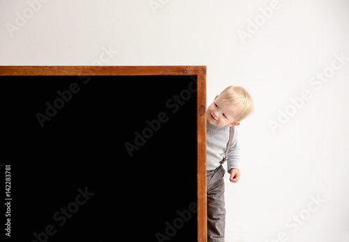 Cute little boy and blackbo...