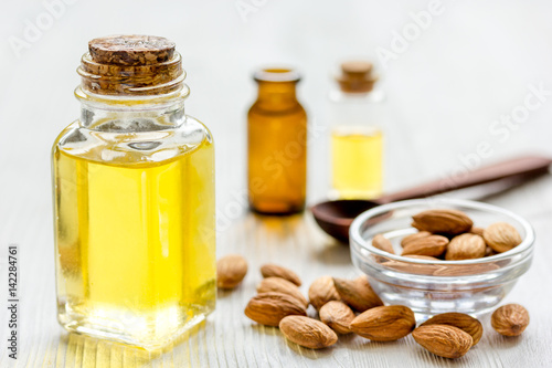 cosmetic set with almond oil on wooden table background