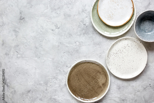 ceramic tableware top view on stone background mock up