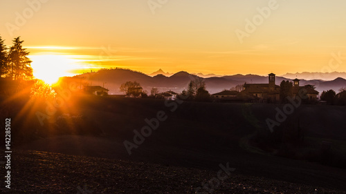 Winter scene. Golden hour in the Monferrato hills. Piedmont, Italy. Monviso in the background.