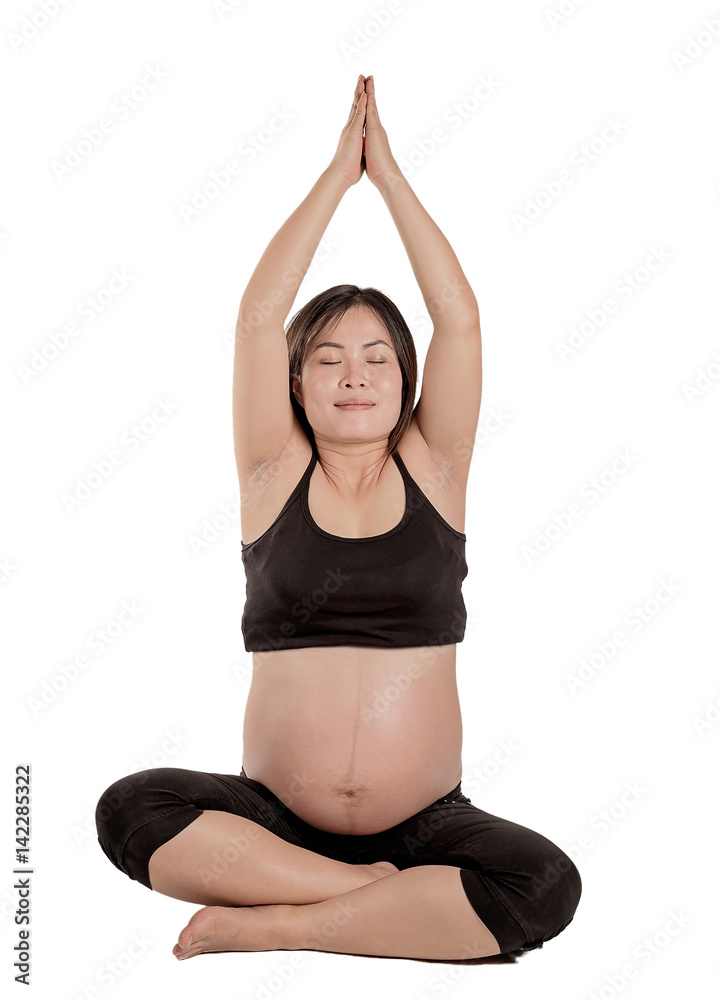 pregnant woman sitting and practicing yoga