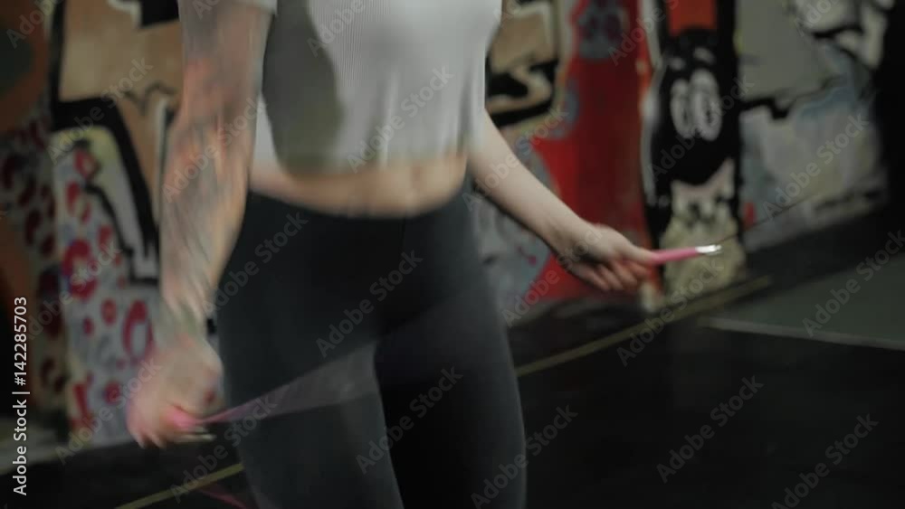 beautiful sporty woman workout with jumping rope in crossfit gym, sexy girl athlete jump beautiful sporty woman workout with jumping rope in crossfit gym, sexy girl athlete jump