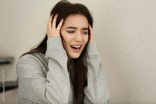 Depressed young woman indoors © Africa Studio