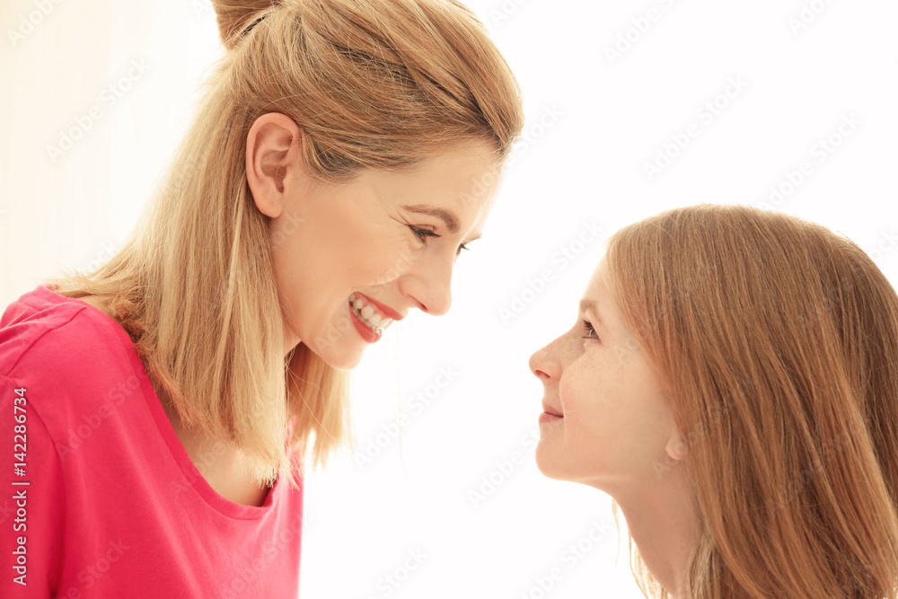 Happy mother and daughter on light background Happy mother and daughter on light background
