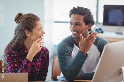 Male and female graphic designers interacting 