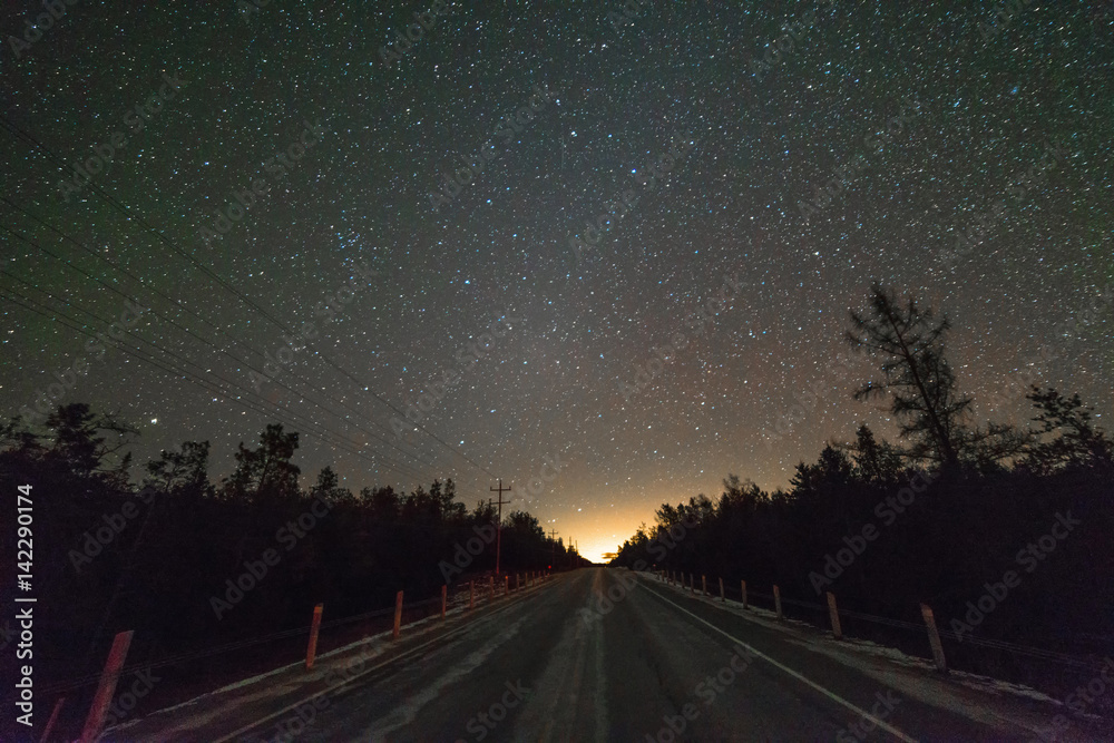 Fototapeta premium Highway in the winter at night with stars