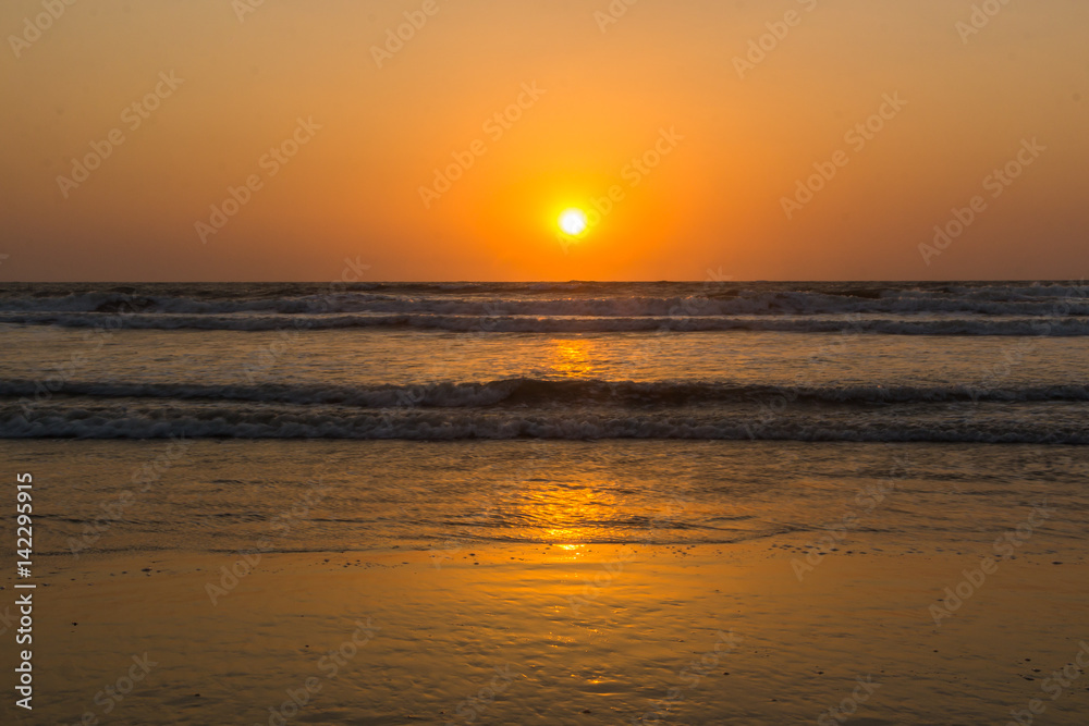 Sunset over Arabian sea, Indian ocean, on Arambol beach, Goa, India