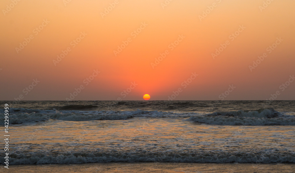 Sunset over Arabian sea, Indian ocean, on Arambol beach, Goa, India