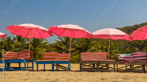Beach chairs and with umbrella on the beach near Sweet lake  Arambol beach  North Goa