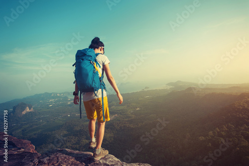 young woman backpacker enjoy the view on mountain peak