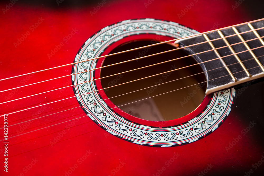 Obraz premium Part of red acoustic guitar. Close up
