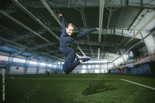 Beautiful young woman in sportswear is engaged in the sports stadium