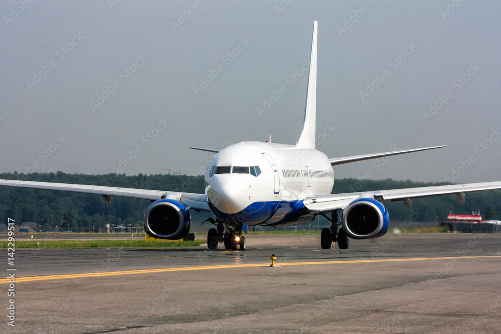 Passenger aircraft moves on the main taxiway Passenger aircraft moves on the main taxiway