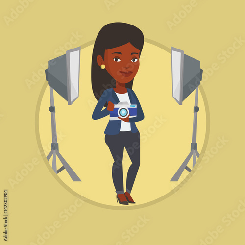 Photographer with camera in photo studio.